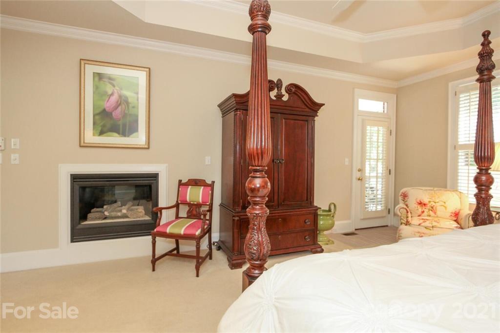 2125 South Wendover Road Charlotte, NC 28211 - Photo 23 of 48 a bedroom with a bed and a fireplace