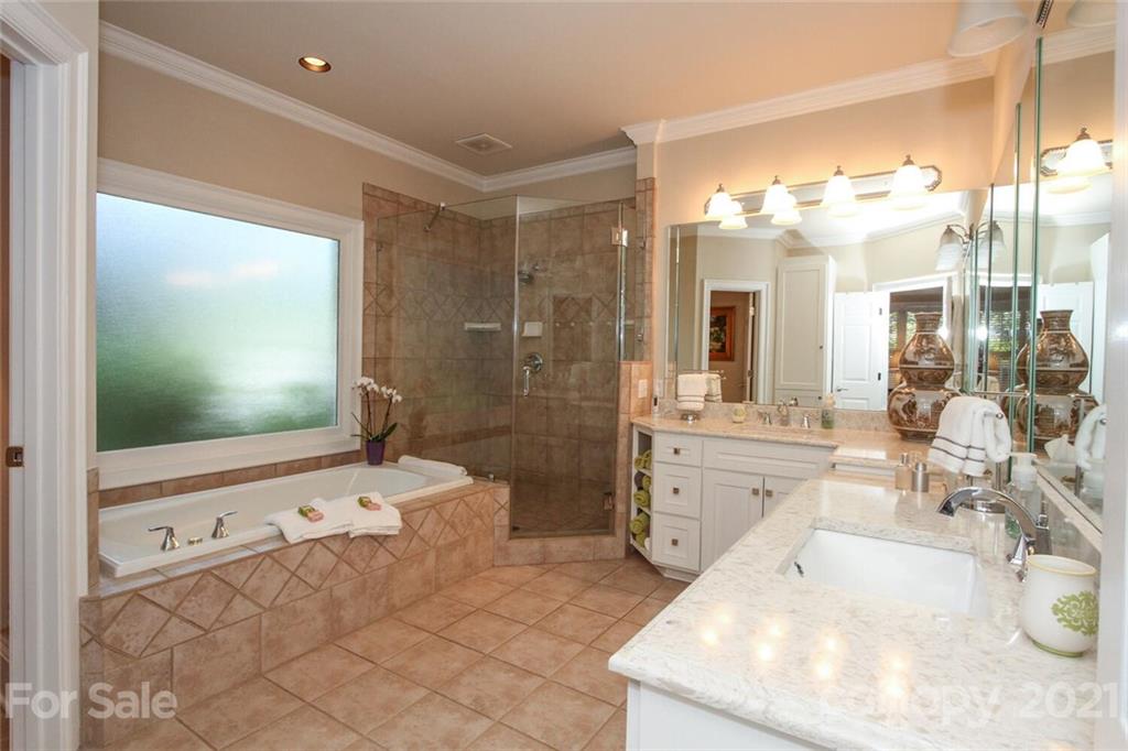 2125 South Wendover Road Charlotte, NC 28211 - Photo 24 of 48 a spacious bathroom with a tub sink mirror and shower