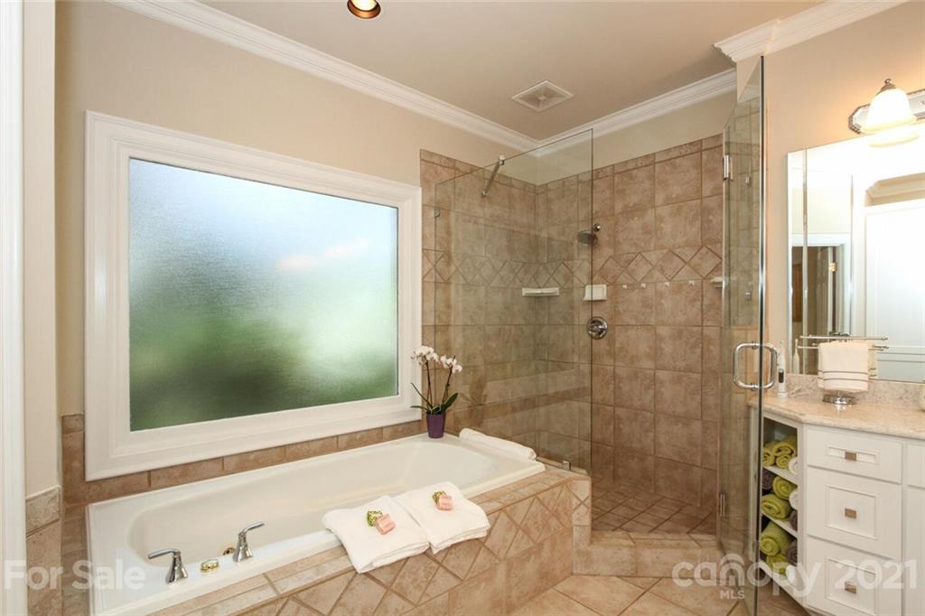 2125 South Wendover Road Charlotte, NC 28211 - Photo 25 of 48 a bathroom with a shower sink and mirror