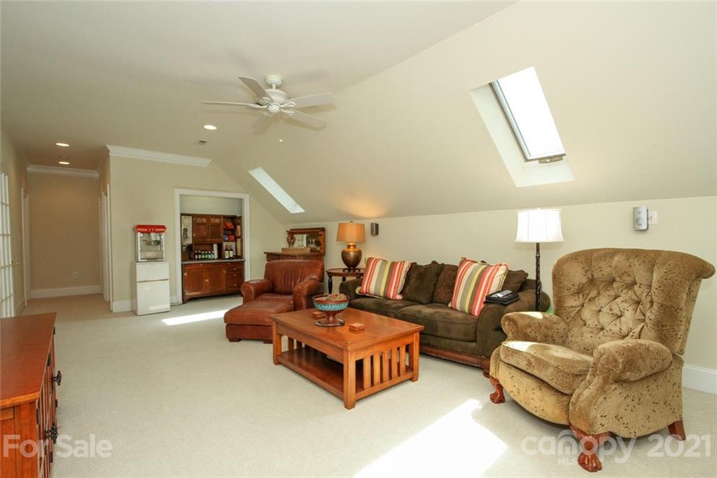 2125 South Wendover Road Charlotte, NC 28211 - Photo 29 of 48 a living room with furniture and a ceiling fan