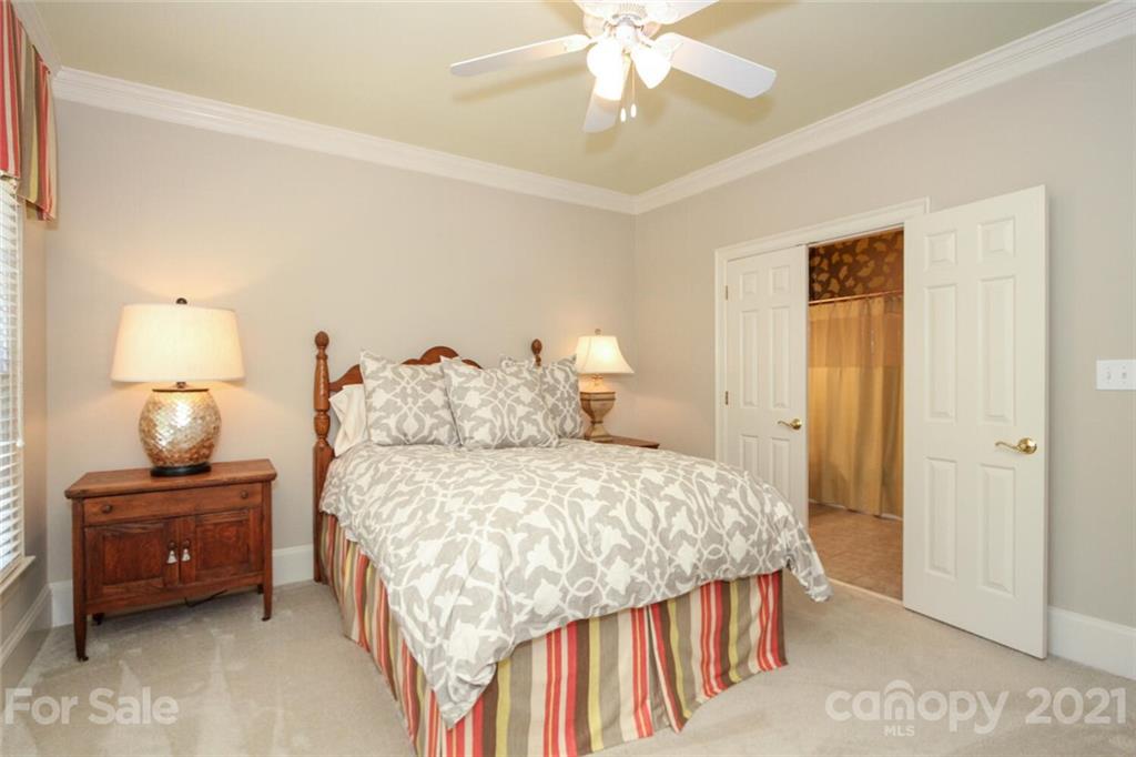 2125 South Wendover Road Charlotte, NC 28211 - Photo 31 of 48 a bedroom with a bed and a lamp on the dresser