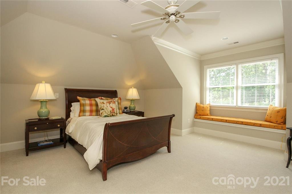 2125 South Wendover Road Charlotte, NC 28211 - Photo 33 of 48 a bedroom with a bed and a chandelier