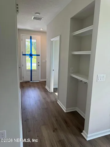an empty room with wooden floor and a window