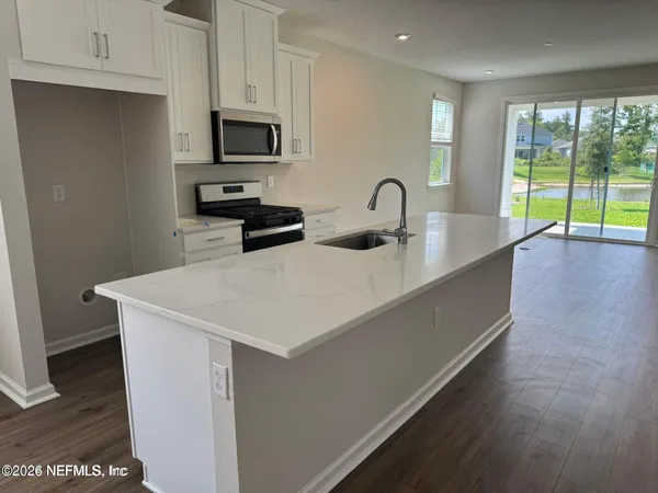 a kitchen with sink a microwave and stove