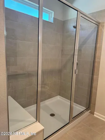 a bathroom with a glass shower door