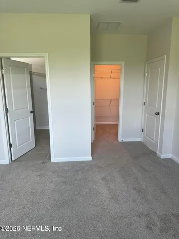 a view of an empty room and closet area