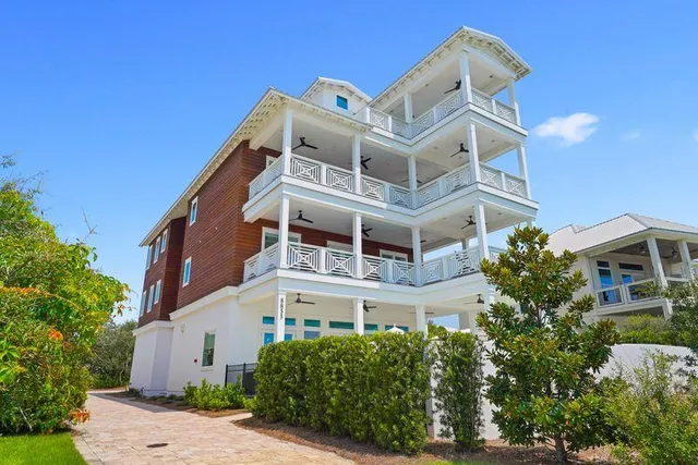 a aerial view of a house with swimming pool and large trees