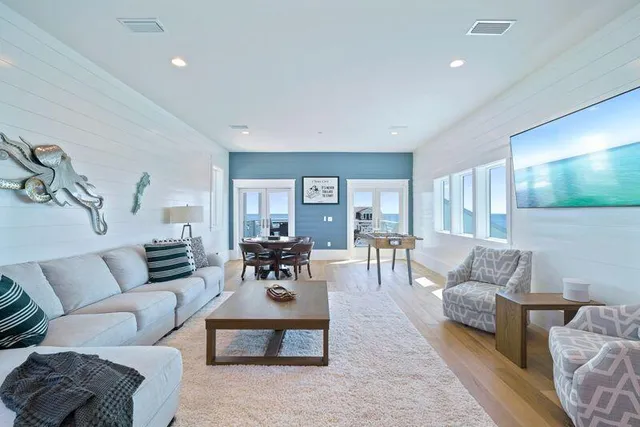 a bedroom with a large bed and wooden floor