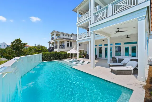 a patio with a table and chairs under an umbrella