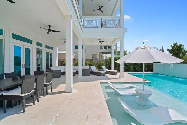 a living room with fireplace furniture and a potted plant