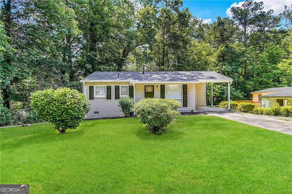 a front view of a house with a garden
