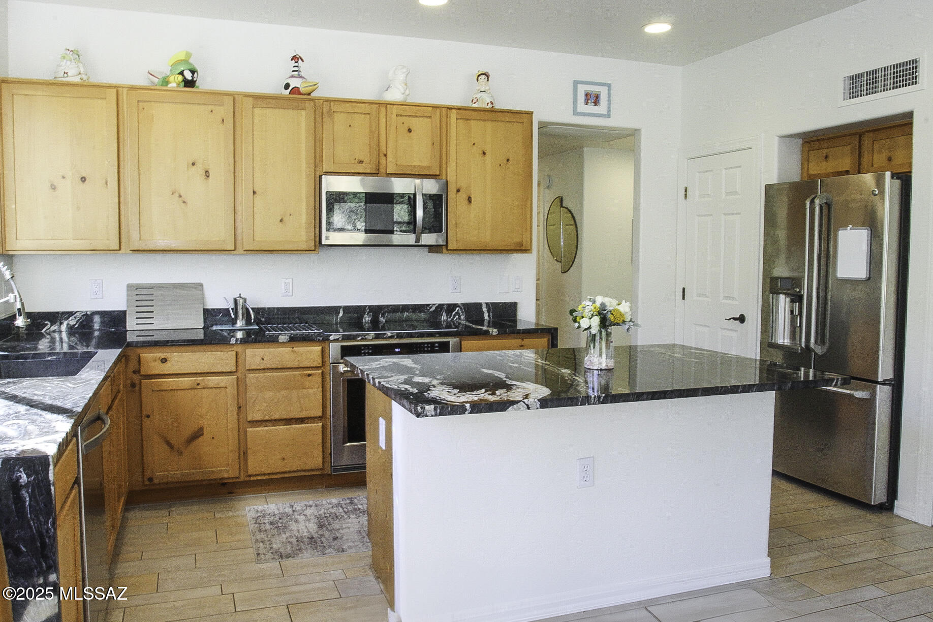 5202 Spring View Drive Tucson, AZ 85749 - Photo 17 of 49 a kitchen with stainless steel appliances granite countertop a sink a stove and a refrigerator