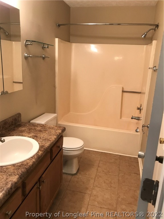 713 Rim Road Fayetteville, NC 28314 - Photo 12 of 16 a bathroom with a granite countertop sink toilet and shower