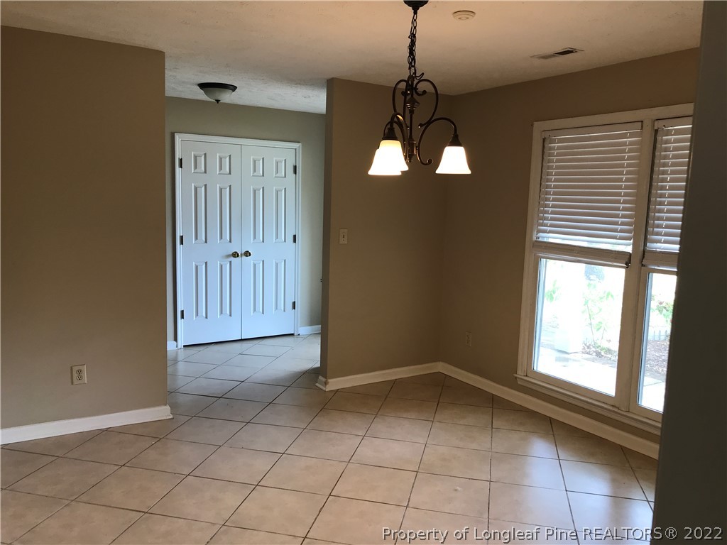 713 Rim Road Fayetteville, NC 28314 - Photo 6 of 16 a view of a livingroom with a chandelier fan and windows