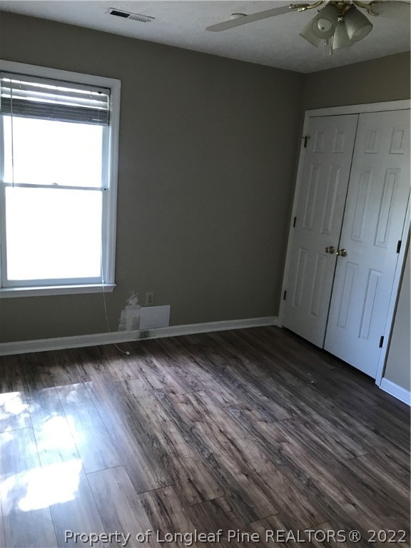 713 Rim Road Fayetteville, NC 28314 - Photo 8 of 16 a view of an empty room with wooden floor and a window