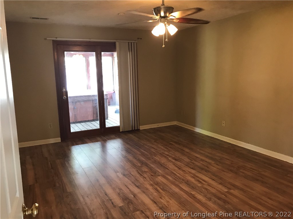713 Rim Road Fayetteville, NC 28314 - Photo 10 of 16 a view of an empty room with wooden floor and fan