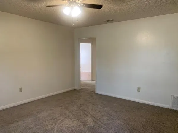 an empty room with a empty space and windows