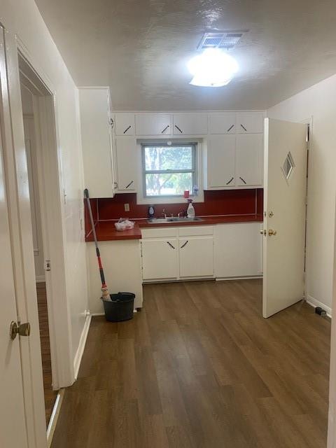 3912 North 22nd Street Waco, TX 76708 - Photo 4 of 16 a view of a kitchen with a sink wooden floor and window