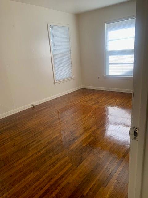 3912 North 22nd Street Waco, TX 76708 - Photo 5 of 16 a view of an empty room with wooden floor and a window