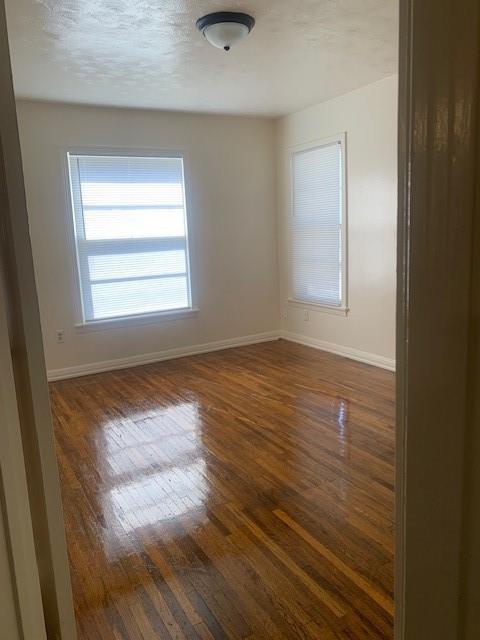 3912 North 22nd Street Waco, TX 76708 - Photo 8 of 16 a view of an empty room with wooden floor and a window