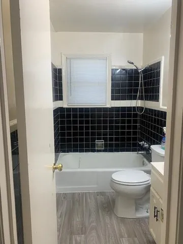 a bathroom with a toilet and a shower