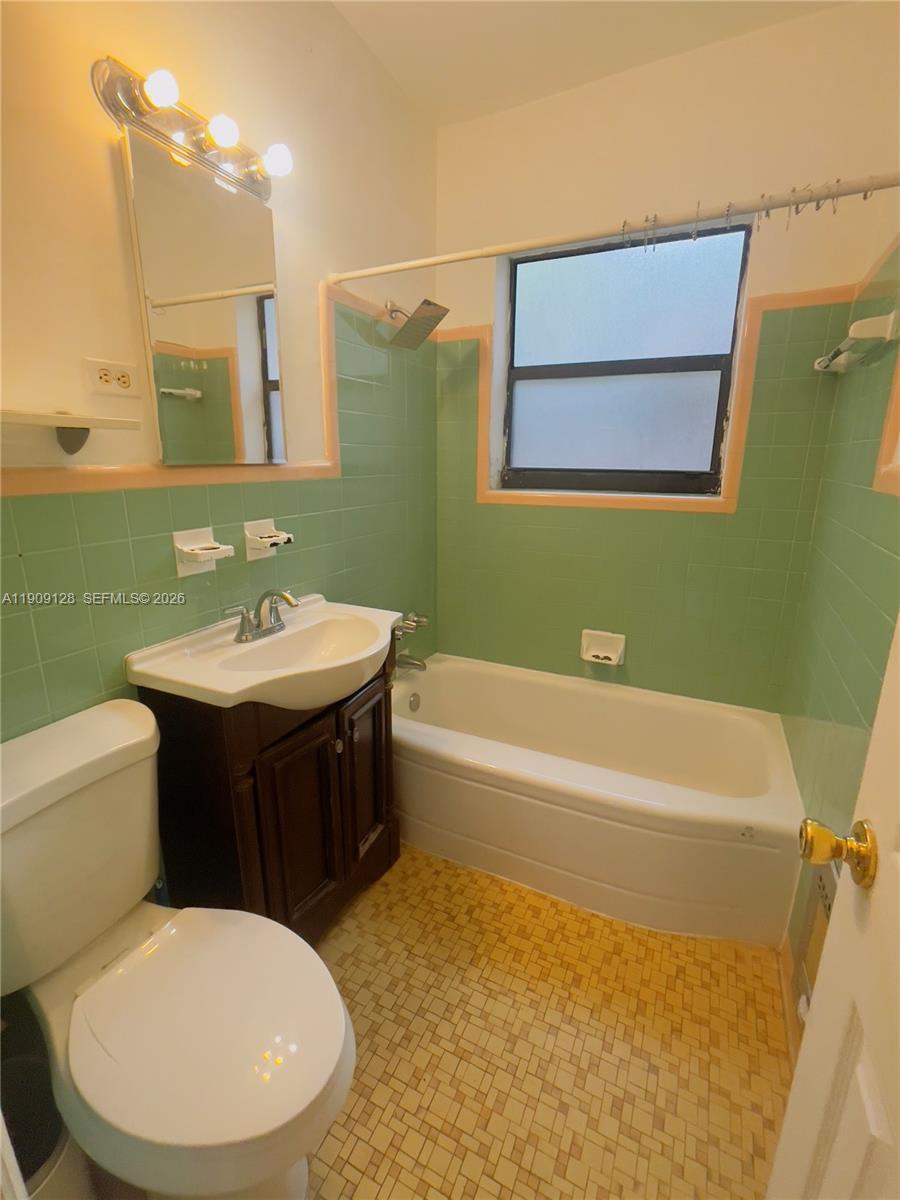 807 86th Street, Unit 805 Miami Beach, FL 33141 - Photo 8 of 10 a bathroom with a sink a toilet and bathtub