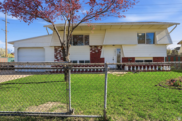1211 Tamarack Road Salt Lake City, UT 84123 - Photo 1 of 1 Bi-level home featuring brick siding and a garage