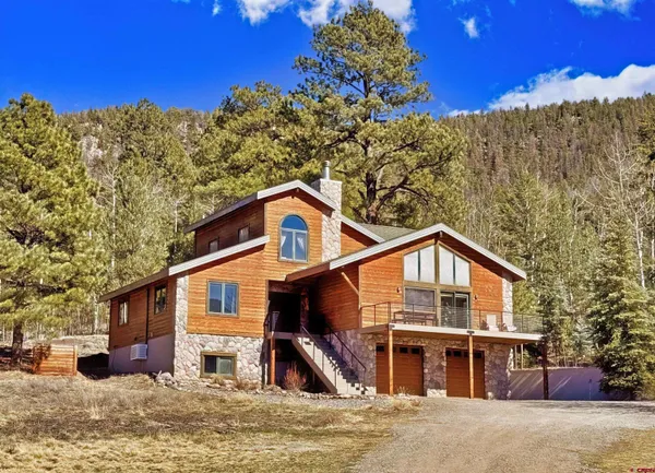 a view of a house with a snow in the background