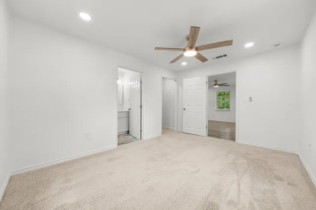 an empty room with fan and a ceiling fan