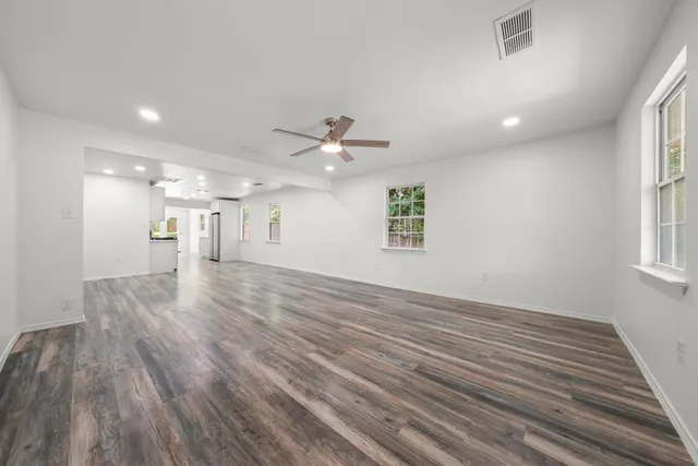 wooden floor in an empty room with a window