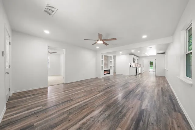 a view of a room with wooden floor and window