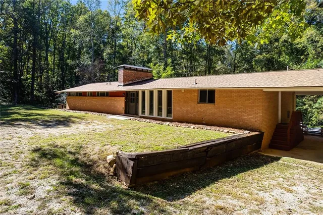 a view of a backyard with chairs