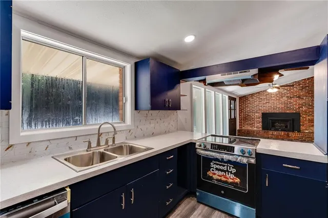 a kitchen with a sink and a refrigerator