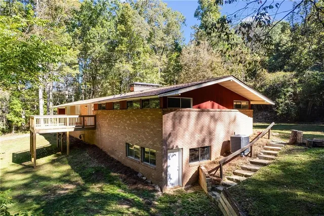 a backyard of house with a yard and seating area