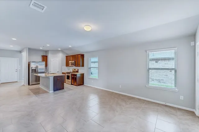 an empty room with furniture and window
