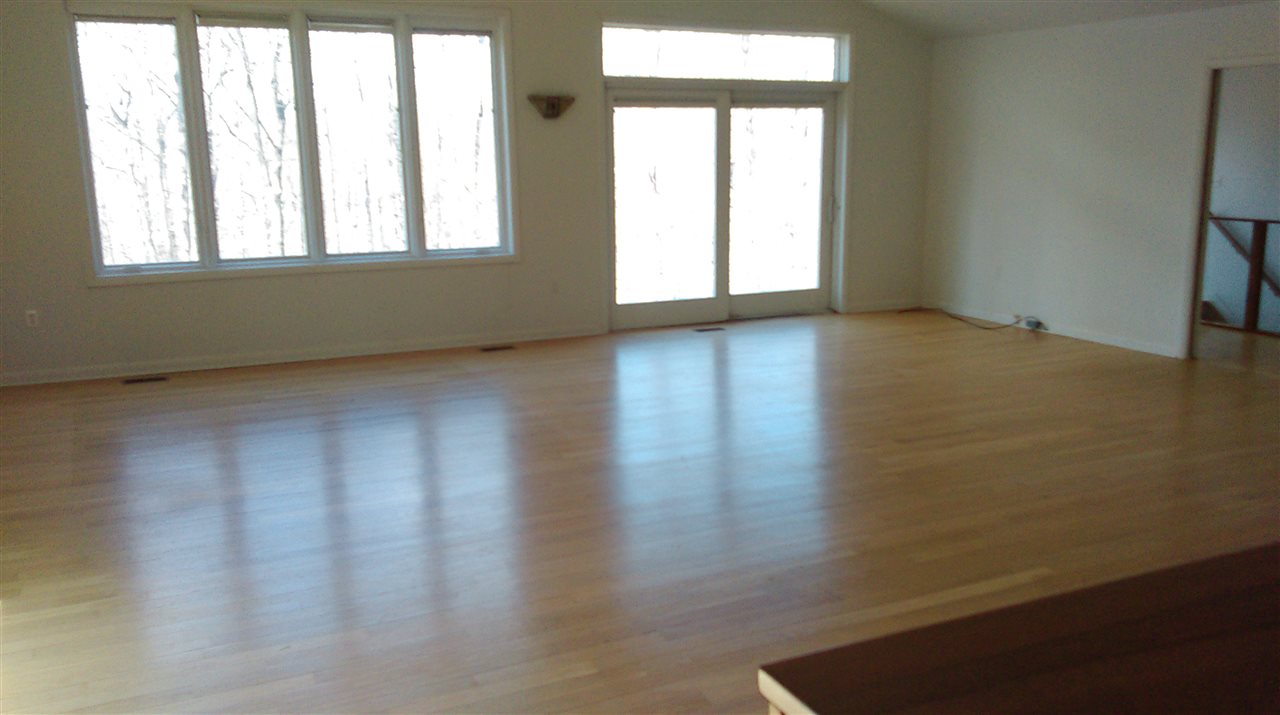 58 Courthouse Mountain Road Madison, VA 22727 - Photo 19 of 37 an empty room with wooden floor and windows