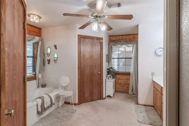 a bathroom with a double vanity sink a mirror and a bathtub