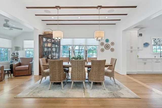 a dining room with furniture a rug and wooden floor