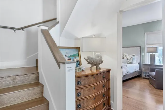 a view of hallway with wooden floor and furniture