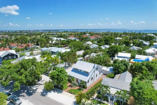 an aerial view of a house with a garden and lake view