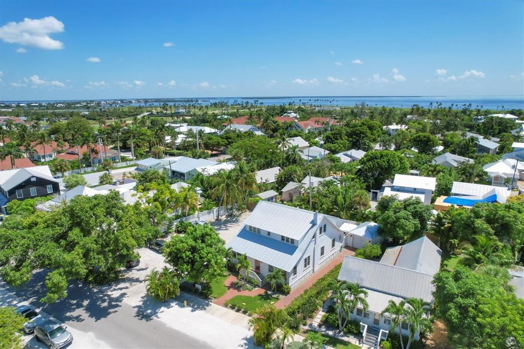 342 Palm Avenue Boca Grande, FL 33921 - Photo 3 of 47 an aerial view of a house with a garden and lake view