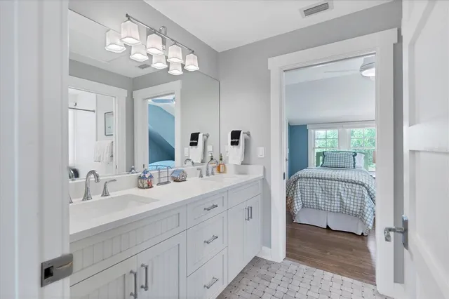 a en suite bathroom with double sink and a mirror