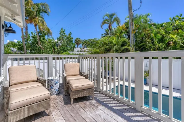 a view of balcony with wooden floor and outdoor seating
