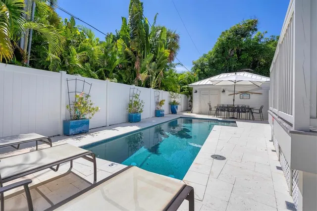 a view of a backyard with sitting area