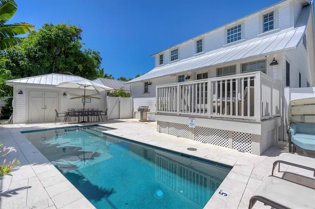 a view of a house with backyard and sitting area