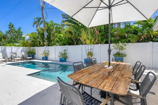 a view of an outdoor dining space with a table and chairs