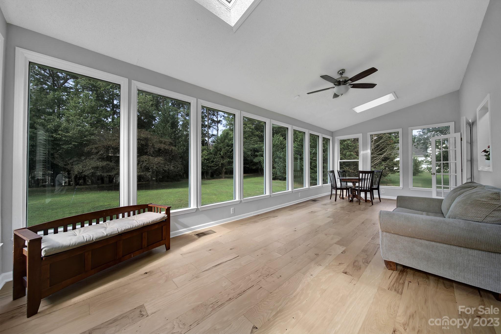 a living room with furniture and a floor to ceiling window