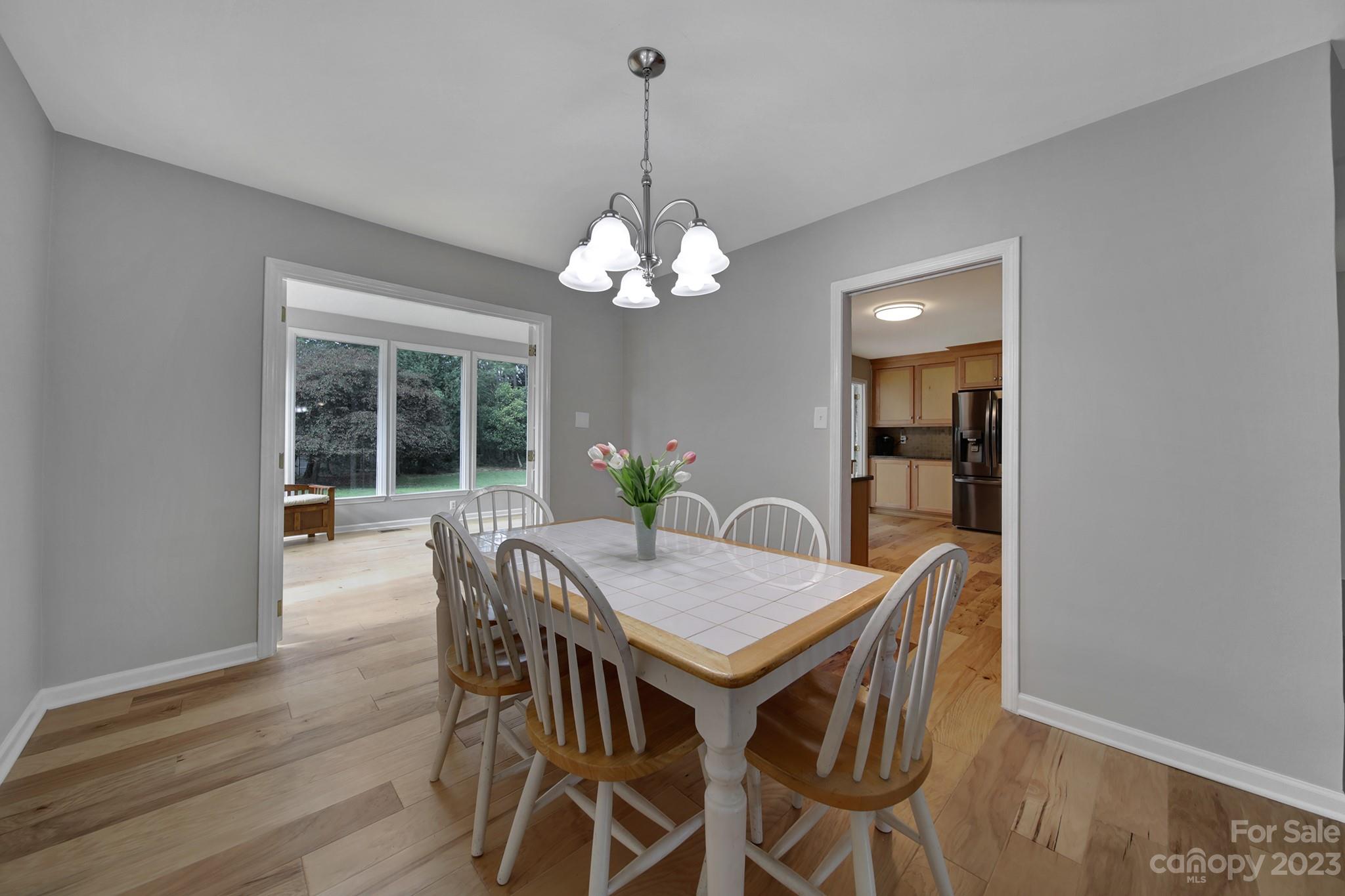 1699 Willowbrook Drive Fort Mill, SC 29708 - Photo 17 of 40 a view of a dining room with furniture wooden floor and chandelier