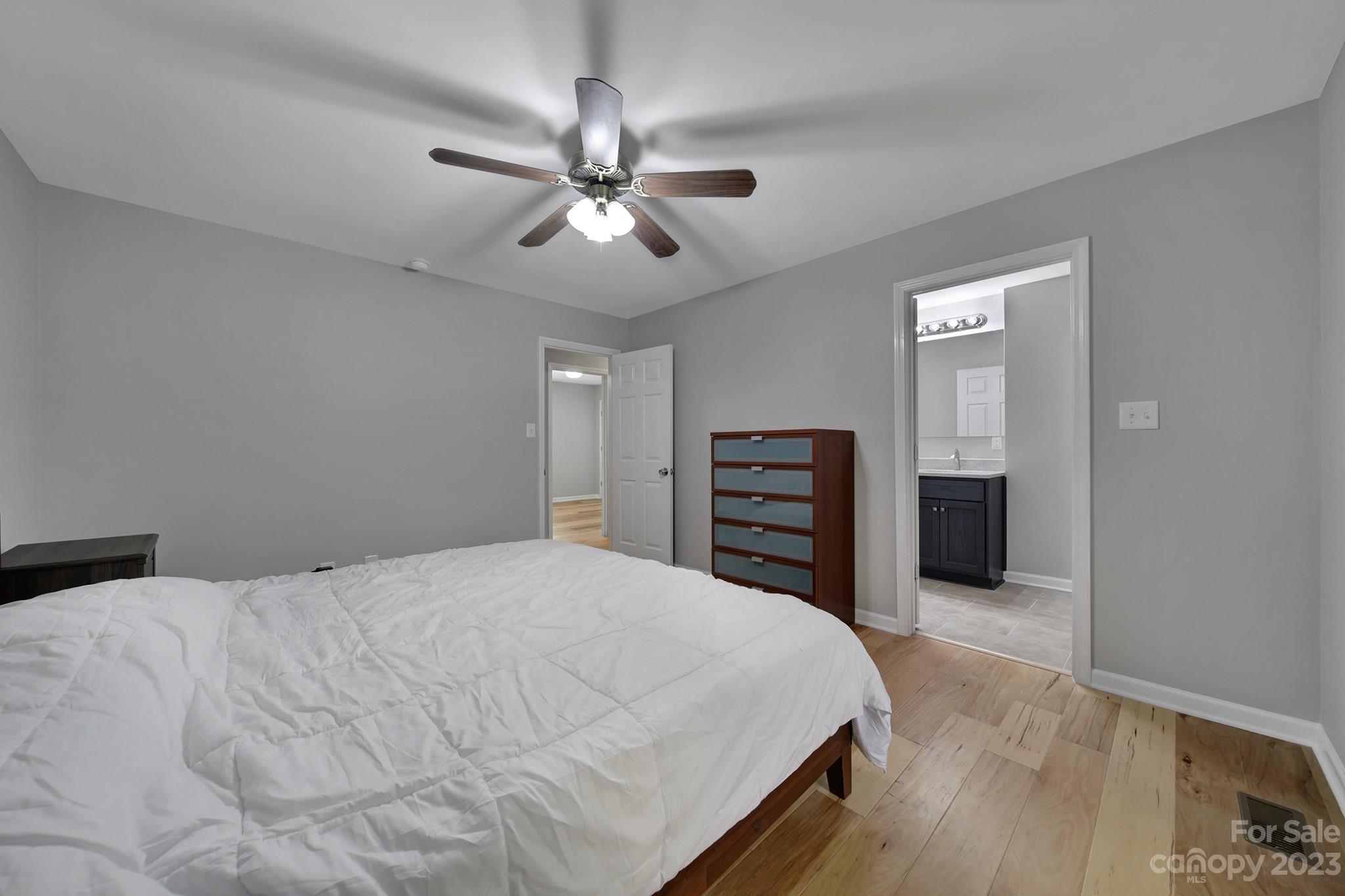 1699 Willowbrook Drive Fort Mill, SC 29708 - Photo 20 of 40 a bedroom with a bed and a chandelier