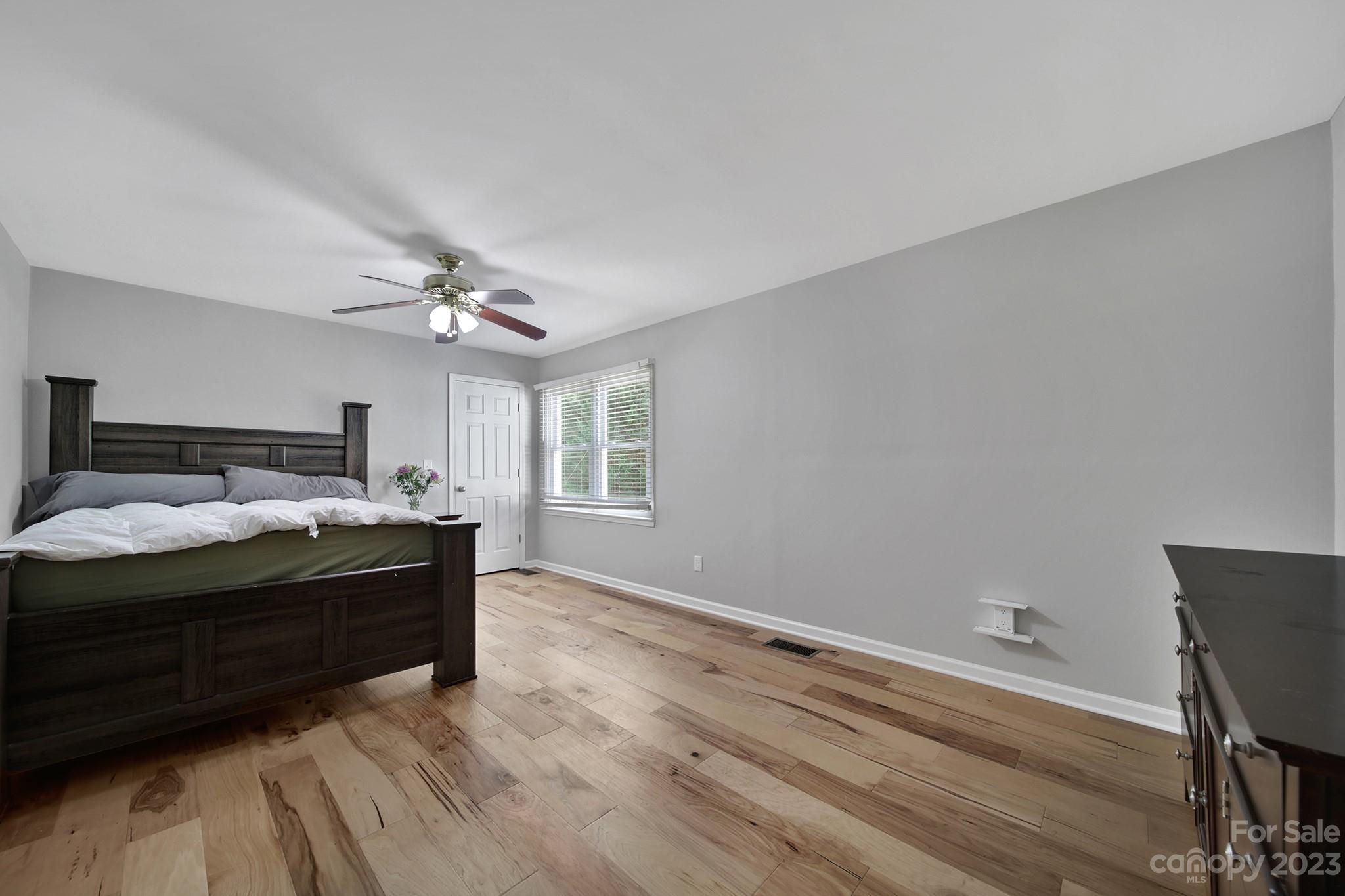 1699 Willowbrook Drive Fort Mill, SC 29708 - Photo 25 of 40 a spacious bedroom with a bed and a chandelier